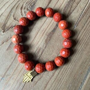 Blessings in Disguise bracelet with a gold toned Hamsa hand charm.